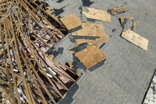 Natural disaster and its consequences. Hurricane Ian destroyed house roof in Florida residential area.