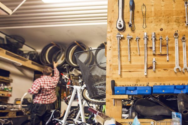 Rear view of man working in bicycle shop
